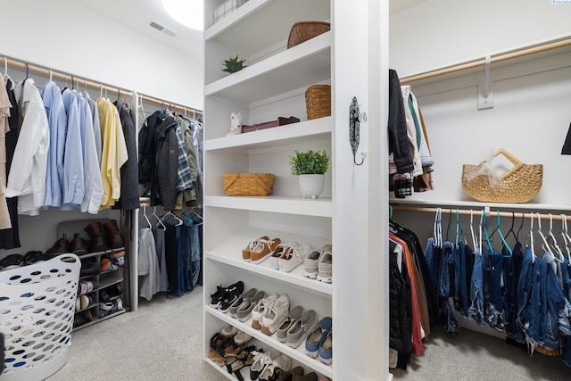 walk in closet with visible vents and carpet flooring