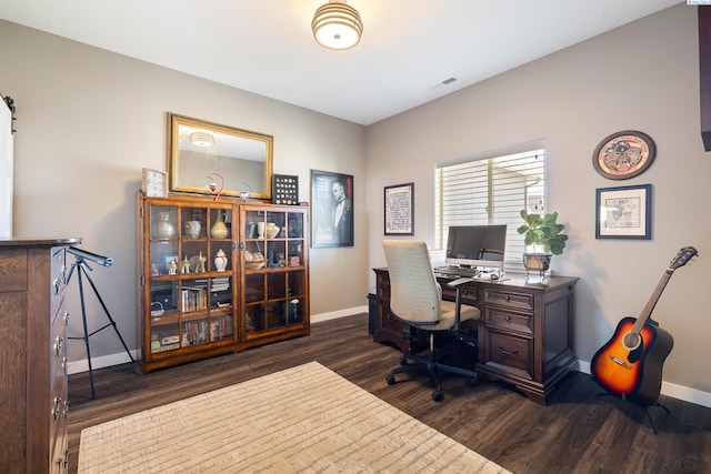 office space featuring baseboards, visible vents, and dark wood-style flooring