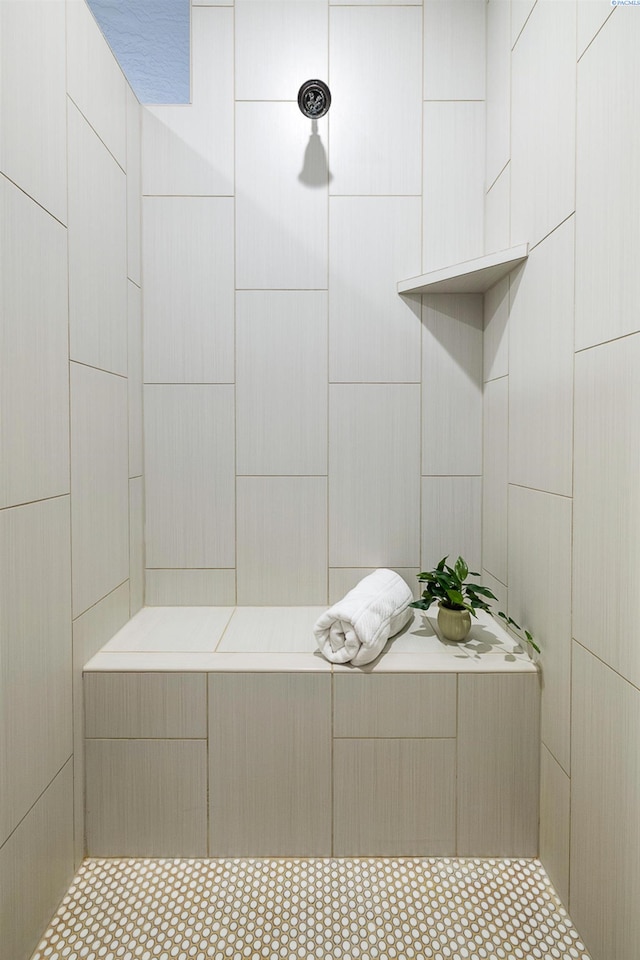 full bath with a tile shower and tile walls