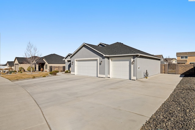 ranch-style house with a garage, driveway, fence, and stucco siding