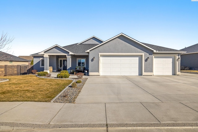 single story home featuring a garage, driveway, a front lawn, and stucco siding