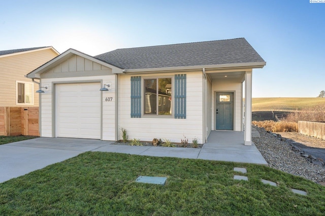 ranch-style home with a garage and a front yard