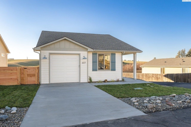 single story home featuring a garage and a front lawn