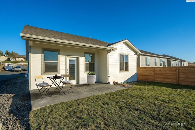 back of house with a yard and a patio area