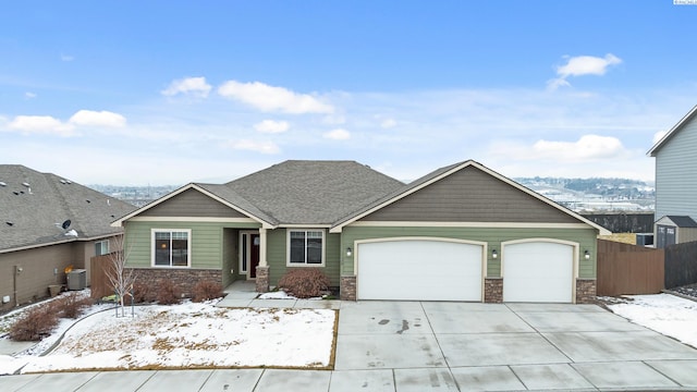 view of front of property featuring cooling unit and a garage