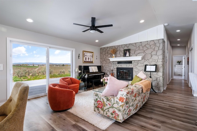 160103 W Byron Rd, Prosser, WA 99350 - living area with vaulted ceiling, a stone fireplace, wood finished floors, and a ceiling fan
