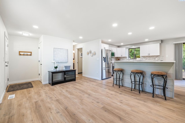 1830 W 23rd Ave, Kennewick, WA 99337 - kitchen featuring stainless steel appliances, a kitchen breakfast bar, tasteful backsplash, white cabinets, and recessed lighting
