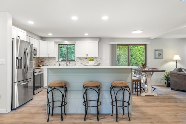 1830 W 23rd Ave, Kennewick, WA 99337 - kitchen featuring stainless steel appliances, a kitchen bar, healthy amount of natural light, and recessed lighting