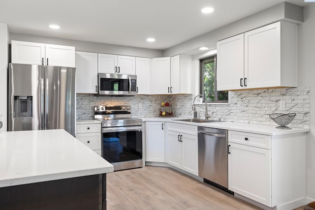 1830 W 23rd Ave, Kennewick, WA 99337 - kitchen featuring stainless steel appliances, a sink, light wood-style floors, recessed lighting, and white cabinetry