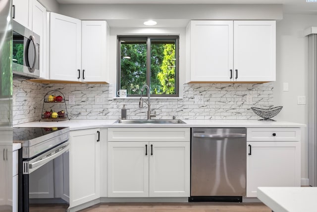 1830 W 23rd Ave, Kennewick, WA 99337 - kitchen featuring stainless steel appliances, a sink, white cabinetry, and light countertops