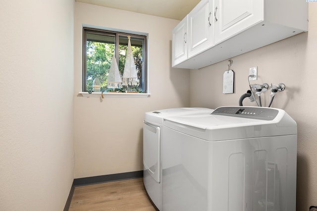 1830 W 23rd Ave, Kennewick, WA 99337 - washroom featuring cabinet space, washer and dryer, light wood-style flooring, and baseboards