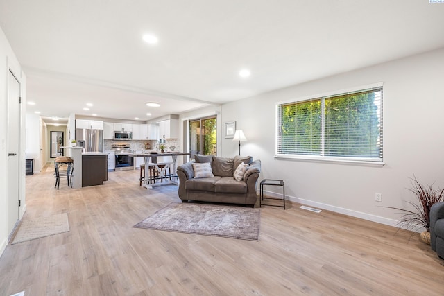 1830 W 23rd Ave, Kennewick, WA 99337 - living room with baseboards, recessed lighting, and light wood-type flooring