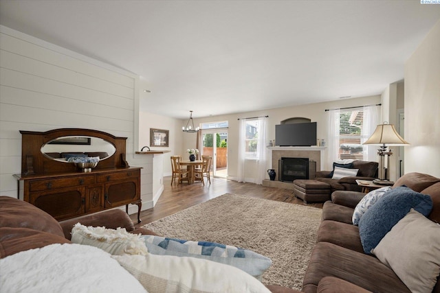 5719 W 15th Ave, Kennewick, WA 99338 - living room with healthy amount of natural light, wood finished floors, a tile fireplace, and a chandelier