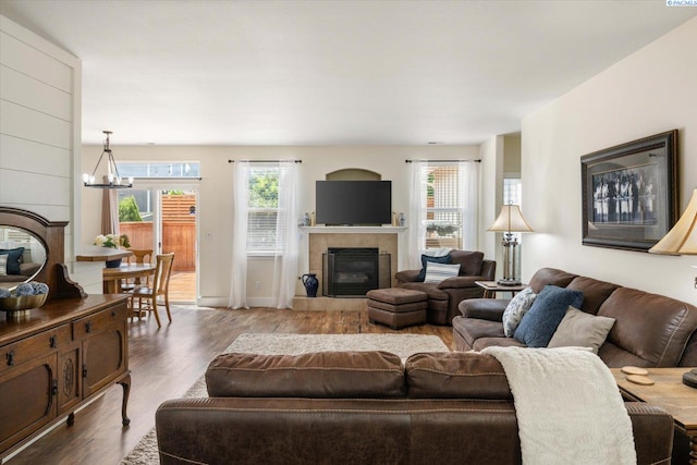 5719 W 15th Ave, Kennewick, WA 99338 - living area with a tiled fireplace, wood finished floors, and a chandelier