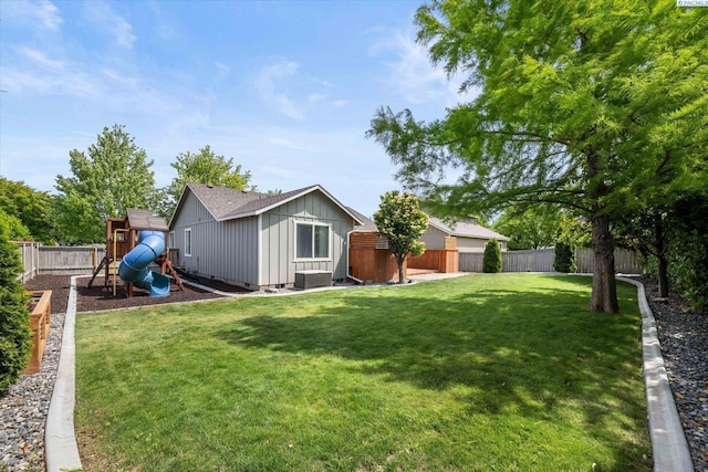 5719 W 15th Ave, Kennewick, WA 99338 - fenced backyard featuring a playground and an outbuilding