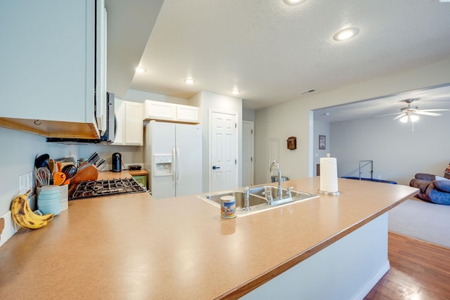 kitchen with white cabinetry, sink, hardwood / wood-style flooring, white refrigerator with ice dispenser, and range