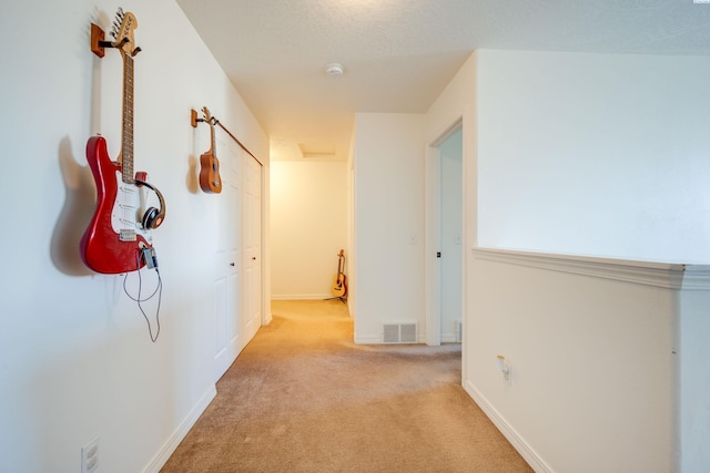 corridor with light colored carpet