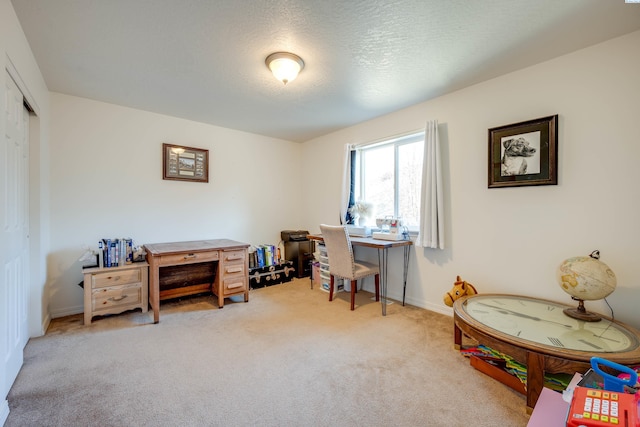 office area with carpet floors and a textured ceiling