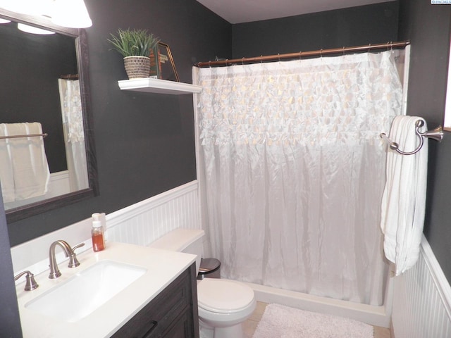 bathroom featuring vanity, toilet, and curtained shower