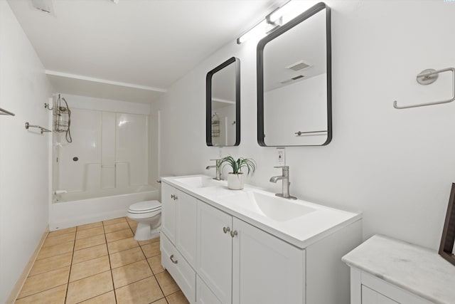 bathroom featuring double vanity, a sink, toilet, and tile patterned floors