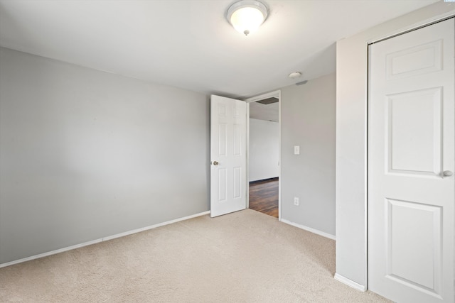 unfurnished bedroom featuring carpet and baseboards