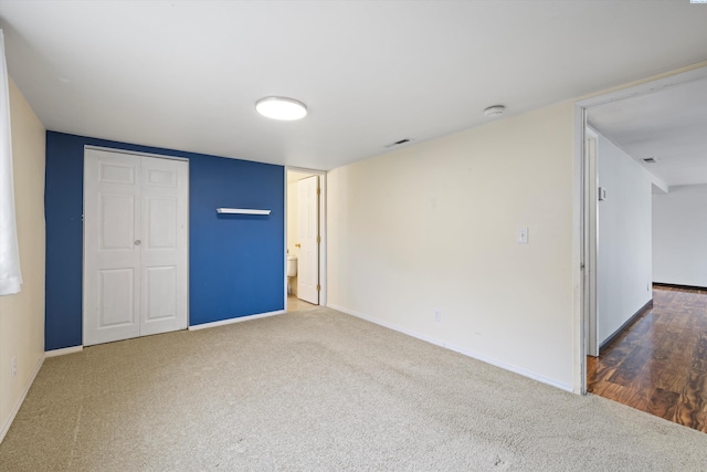 interior space with carpet, baseboards, visible vents, and a closet