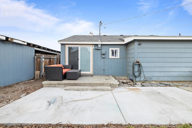 back of property featuring a patio and fence