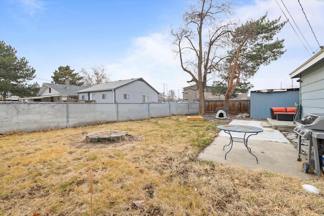 view of yard featuring an outdoor fire pit, a fenced backyard, and a patio