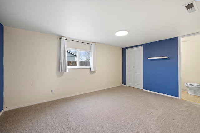 interior space with carpet floors, a closet, visible vents, and baseboards