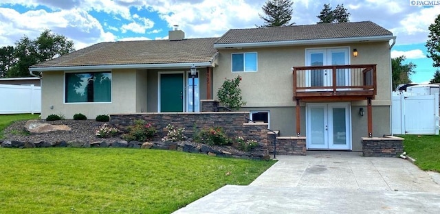 view of front of home featuring french doors, a front yard, fence, and stucco siding