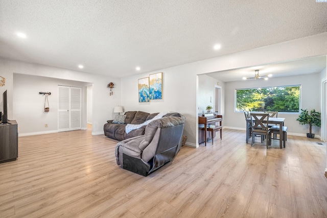 1112 Mcmurray St, Richland, WA 99354 - living room featuring a textured ceiling, light wood-type flooring, recessed lighting, a chandelier, and baseboards