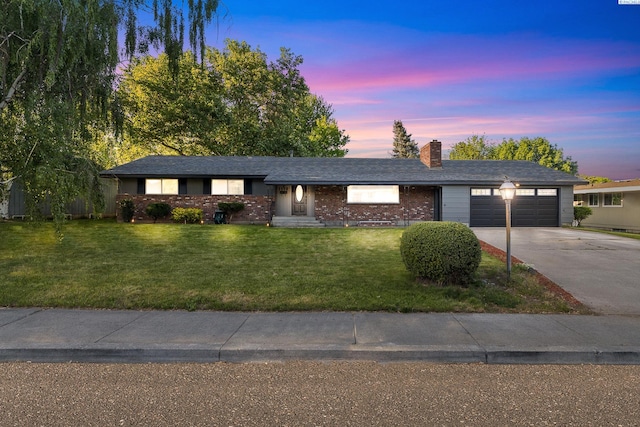 1112 Mcmurray St, Richland, WA 99354 - single story home featuring a garage, concrete driveway, a chimney, a lawn, and brick siding