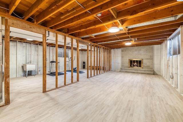 1112 Mcmurray St, Richland, WA 99354 - unfinished below grade area with wood finished floors, a brick fireplace, and a sink