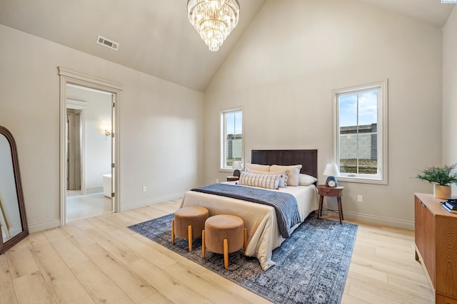 bedroom featuring high vaulted ceiling, light hardwood / wood-style flooring, and a notable chandelier