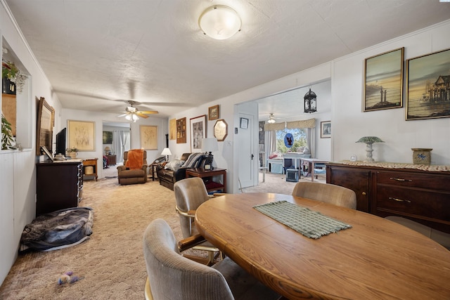 dining area featuring a ceiling fan and carpet flooring