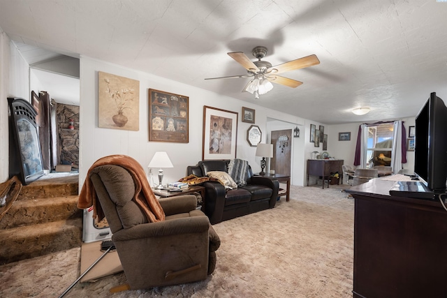 carpeted living room featuring a ceiling fan