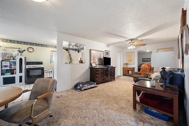 carpeted living room with a ceiling fan