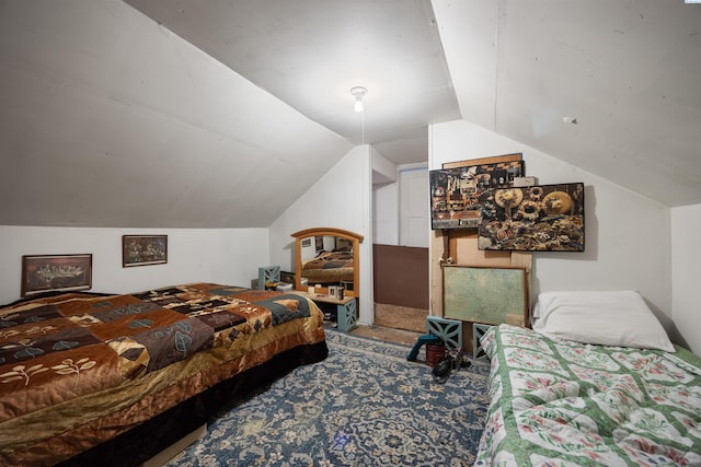 bedroom featuring vaulted ceiling and carpet