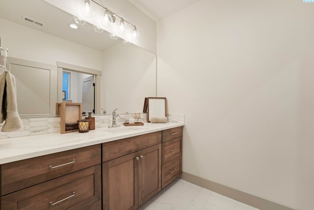 bathroom featuring vanity and backsplash