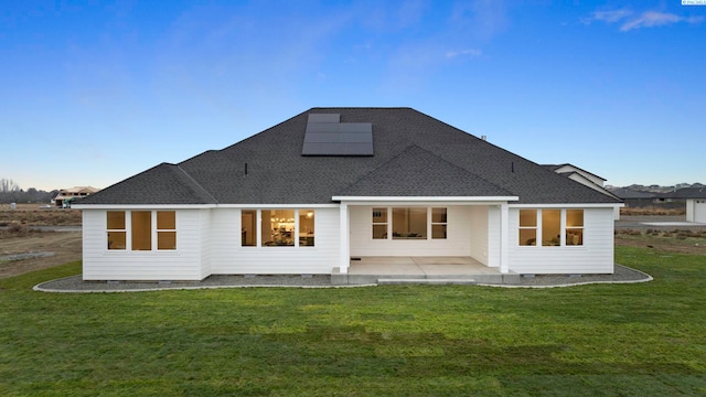 rear view of house featuring a lawn and a patio area