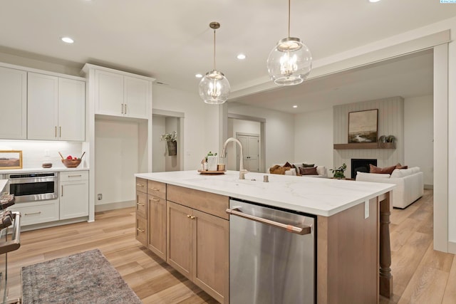 12712 Blackfoot Dr, Pasco, WA 99301 - kitchen with white cabinetry, sink, dishwasher, and a center island with sink