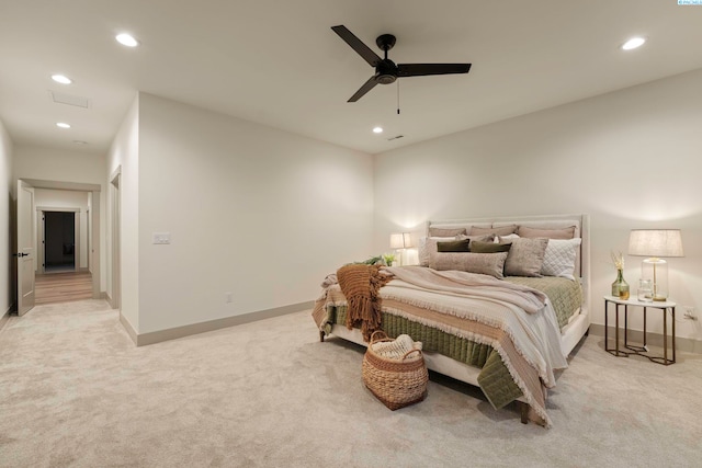 bedroom featuring light colored carpet and ceiling fan