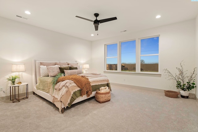 bedroom with ceiling fan and light colored carpet