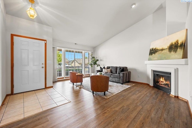 2418 S Arthur Ct, Kennewick, WA 99338 - living room featuring lofted ceiling, wood finished floors, and a glass covered fireplace