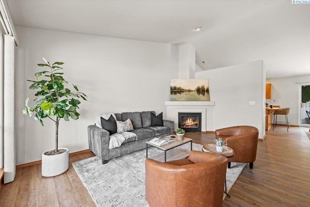 2418 S Arthur Ct, Kennewick, WA 99338 - living area featuring a glass covered fireplace, lofted ceiling, and wood finished floors