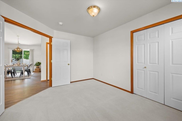 2418 S Arthur Ct, Kennewick, WA 99338 - unfurnished bedroom featuring light colored carpet and a chandelier