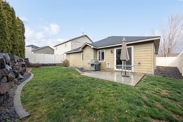 rear view of house featuring a yard and a patio area