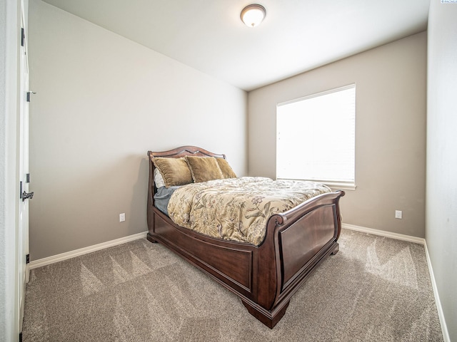 bedroom with carpet flooring and baseboards