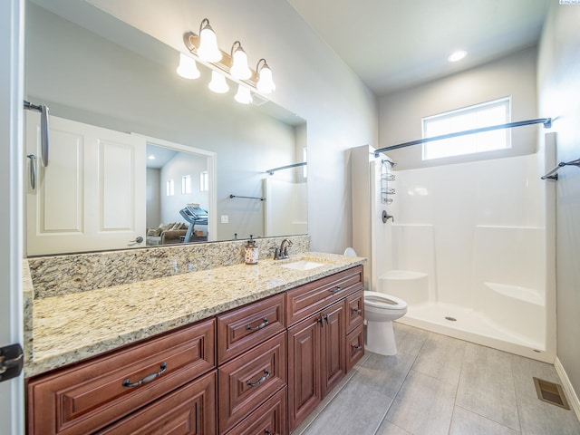 full bath featuring a shower, visible vents, vanity, and toilet