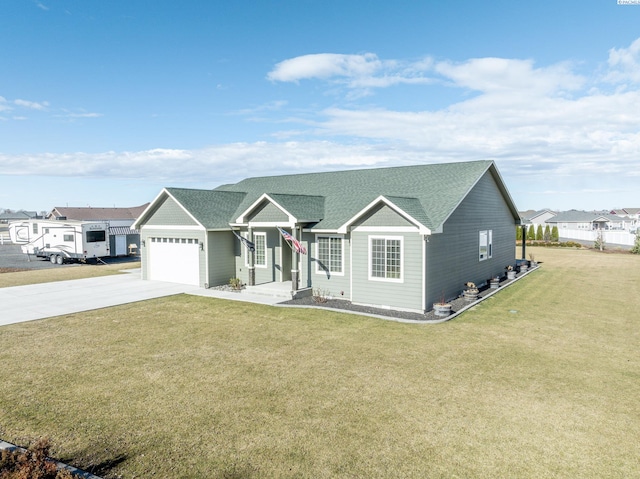 ranch-style house featuring a front yard, concrete driveway, roof with shingles, and an attached garage